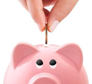 Coin being put into a piggy bank